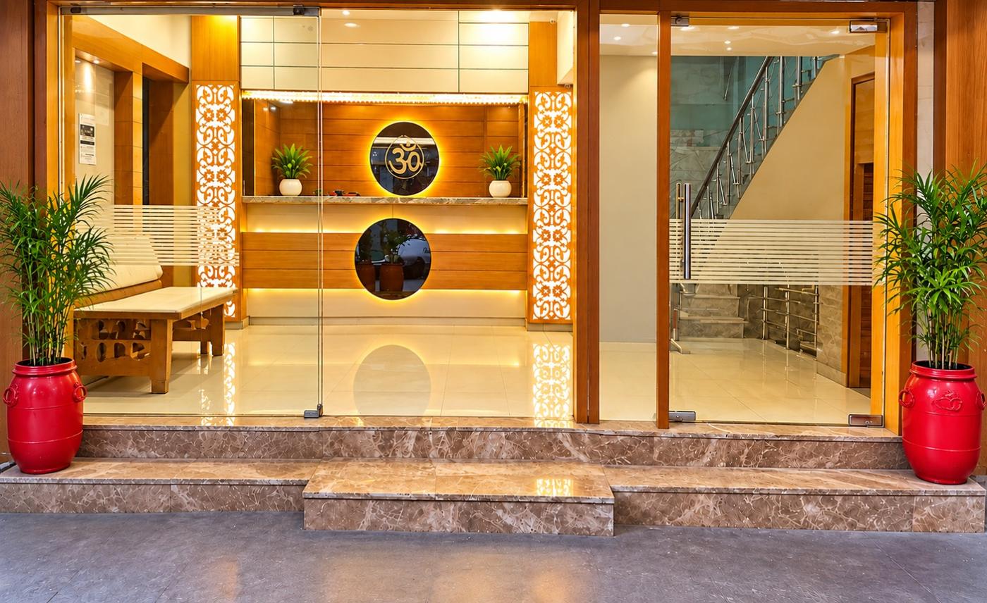 Hotel Neelam reception with wooden panelling, Om emblem and marble floor